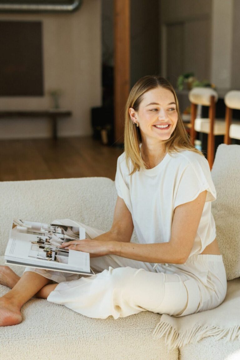 woman reading book couch 865x1296