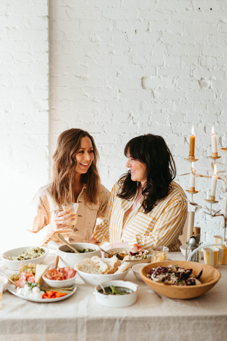 women smiling at dinner 865x1298