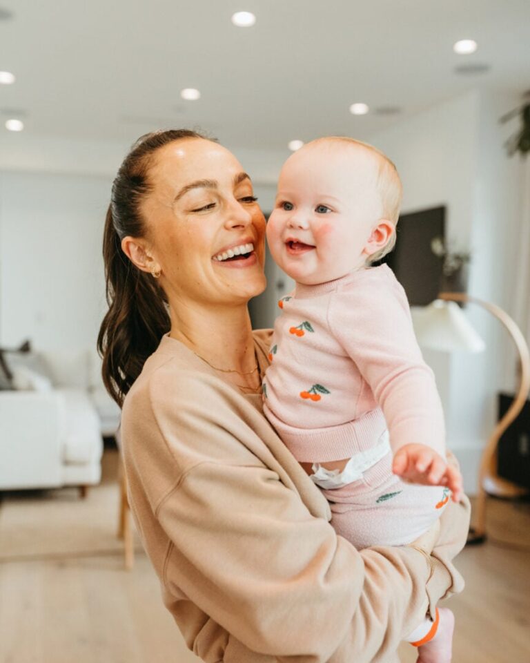 woman holding baby 865x1081