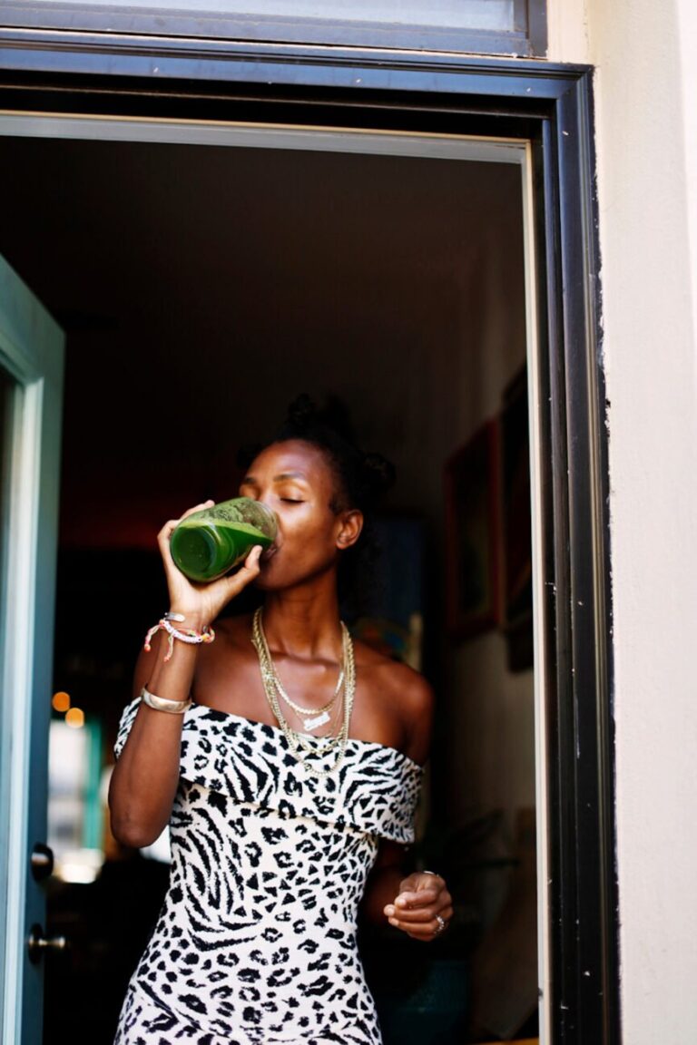 woman drinking green juice 865x1298