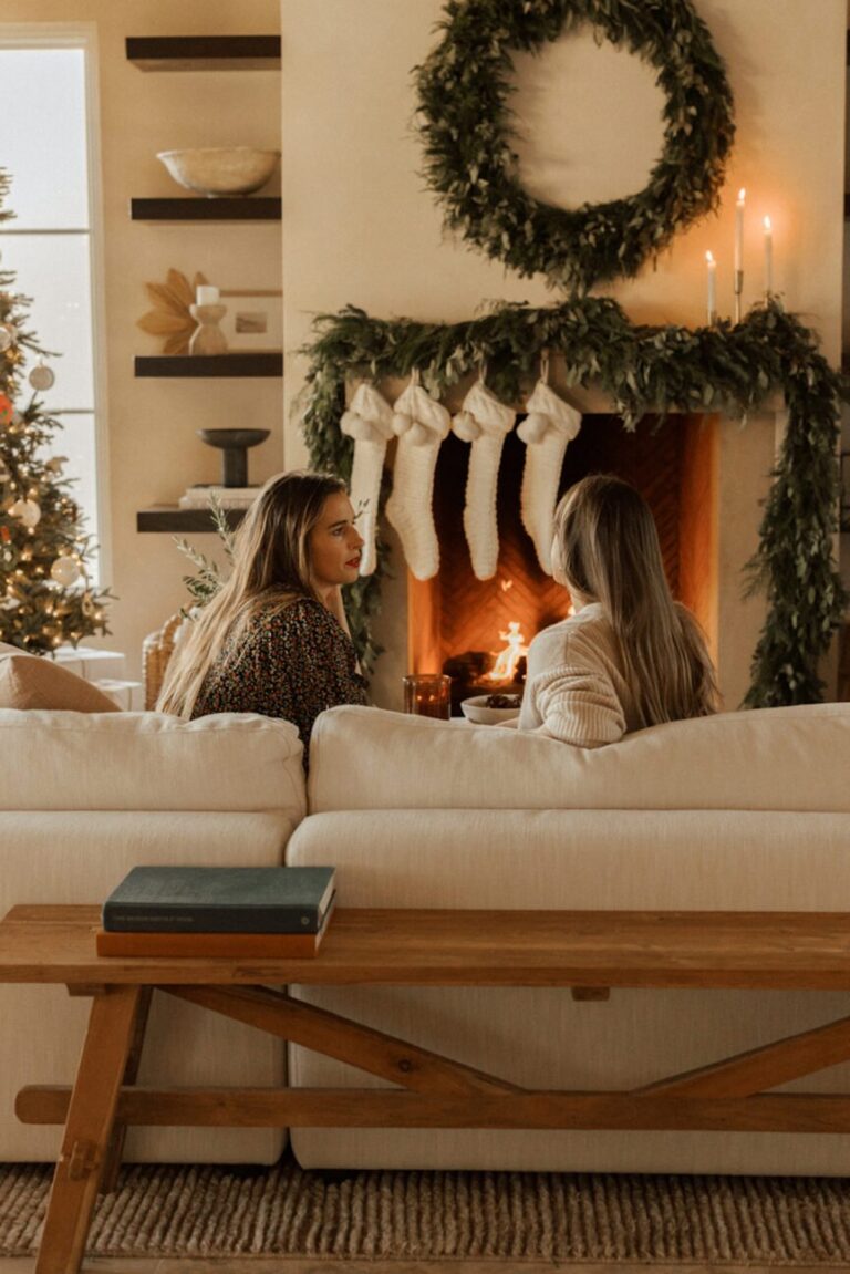 women talking by fireplace 865x1296