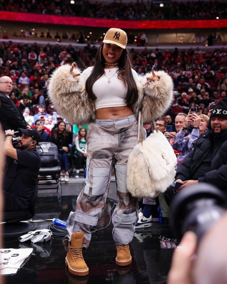 9 Megan Thee Stallion Attends the Bulls vs Celtics Game in a DSquared Fur Coat Who Decides War Cargo Pants and a YSL Niki Oversized Fur Bag