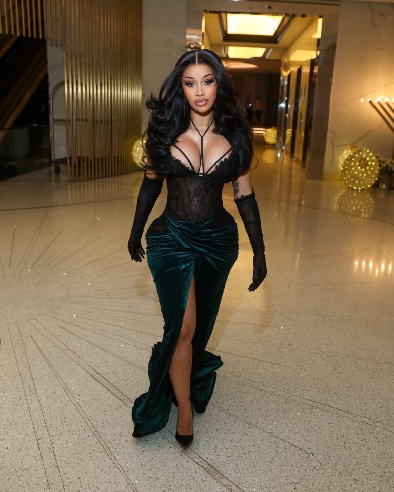 2 Cardi B Celebrates the New Year in a Mimoza Kadriaj Black Velvet Drape Gown and a Custom Jordon Wllis Pink and Green Lace Mini Dress